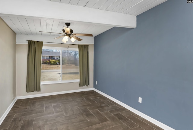 empty room with dark parquet floors, ceiling fan, and beamed ceiling