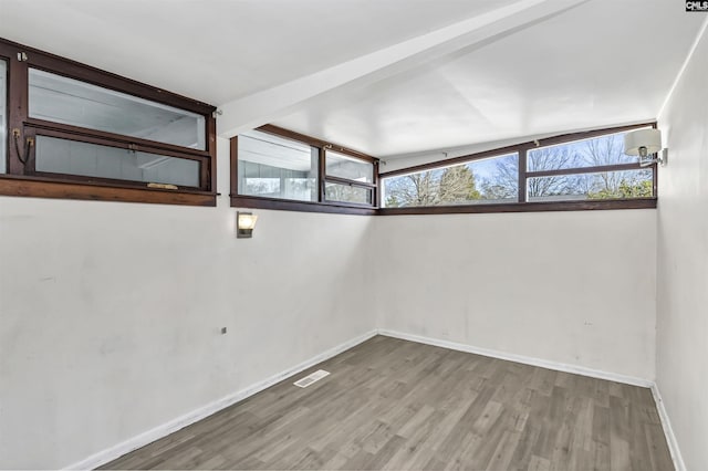 unfurnished room featuring hardwood / wood-style flooring