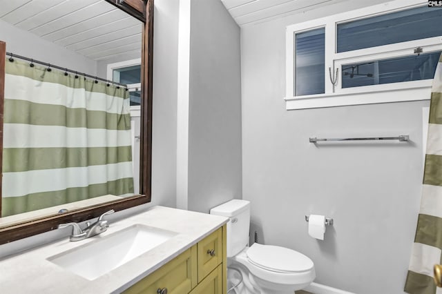 bathroom featuring toilet, vanity, and wood ceiling