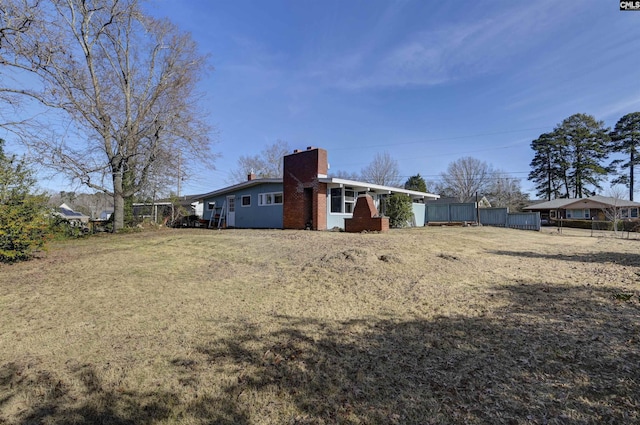 back of house featuring a yard