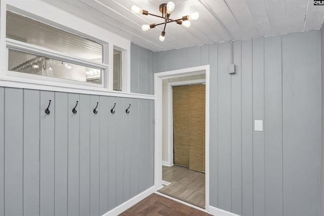 mudroom featuring an inviting chandelier and parquet floors