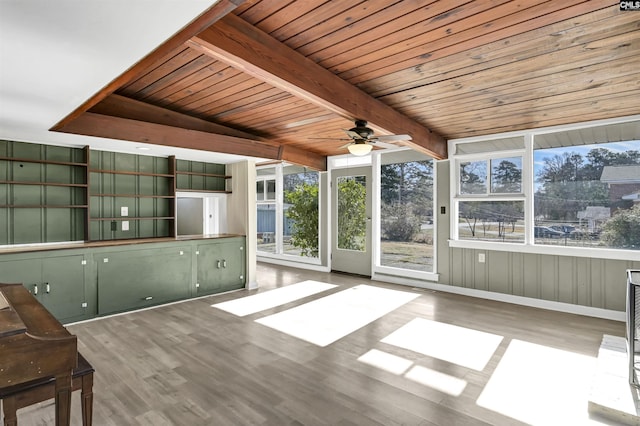 unfurnished sunroom featuring wooden ceiling, ceiling fan, and beamed ceiling