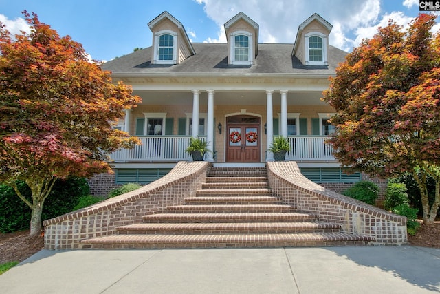 view of front of property with covered porch and french doors