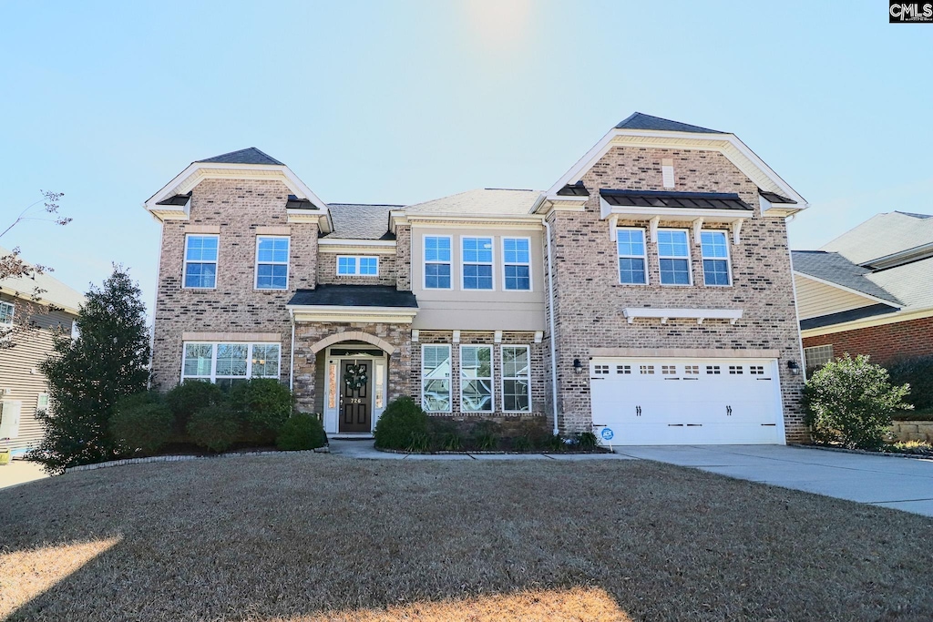 view of front facade with a front yard and a garage