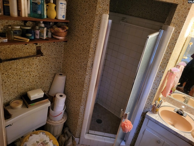 bathroom featuring toilet, walk in shower, and vanity