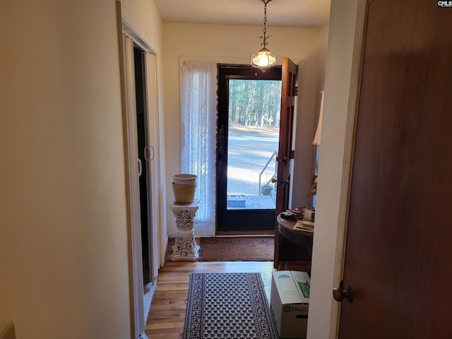 doorway featuring light wood-type flooring and heating unit