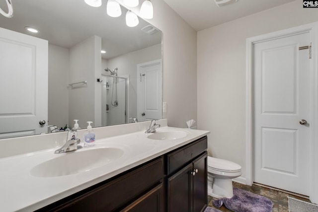 bathroom with toilet, walk in shower, and vanity