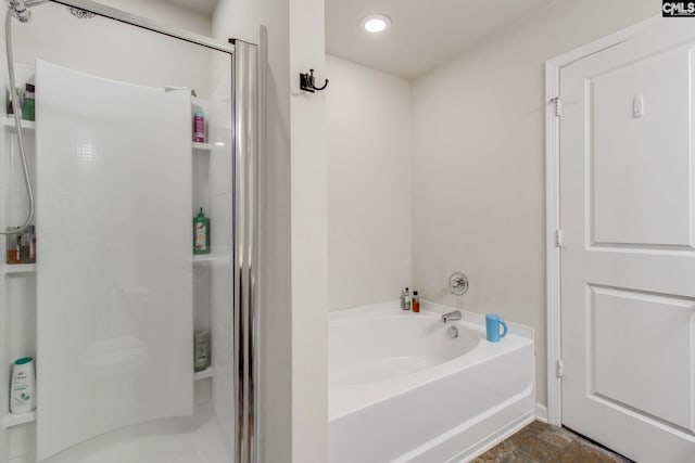 bathroom featuring shower with separate bathtub