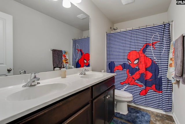 bathroom featuring toilet, vanity, and walk in shower