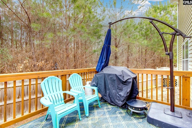 wooden terrace with a grill