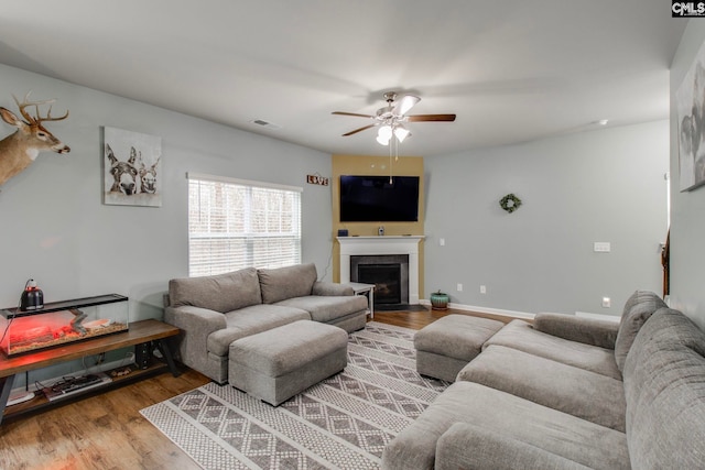 living room with ceiling fan and wood-type flooring