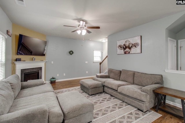 living room with ceiling fan and hardwood / wood-style flooring