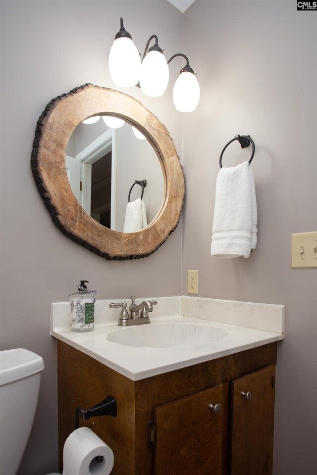 bathroom featuring toilet and vanity