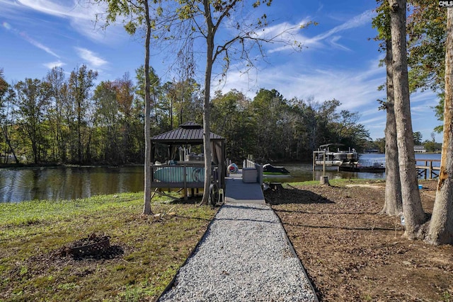 view of dock featuring a gazebo and a water view