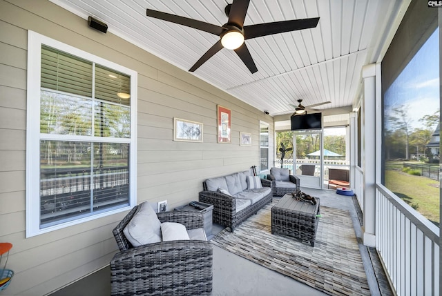 sunroom featuring ceiling fan