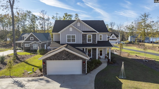 view of front of home with covered porch, a front lawn, and a garage