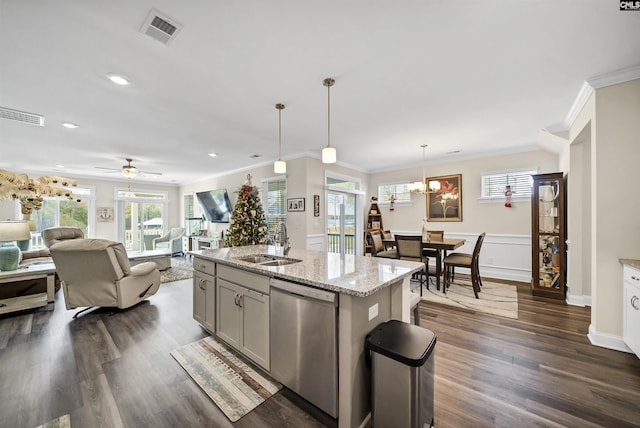 kitchen with sink, stainless steel dishwasher, ceiling fan with notable chandelier, a center island with sink, and pendant lighting