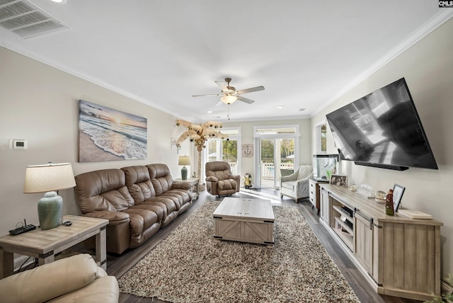 living room with ornamental molding, ceiling fan, and dark hardwood / wood-style floors