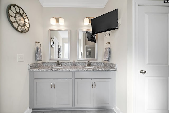 bathroom with tile patterned floors, crown molding, and vanity