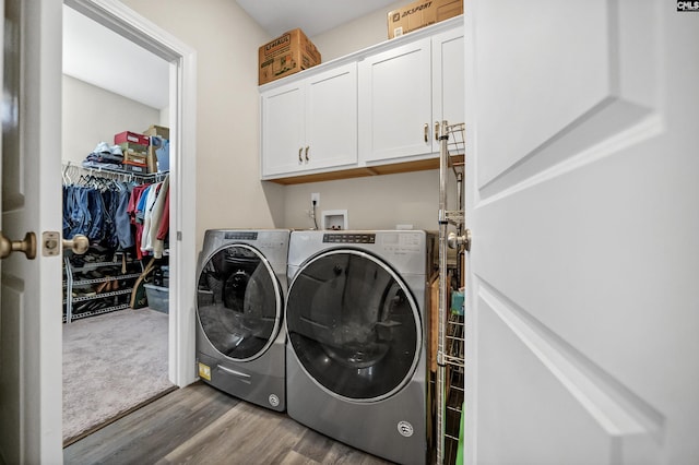 laundry area featuring cabinets, separate washer and dryer, and hardwood / wood-style floors