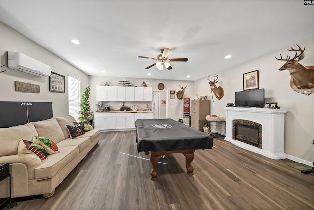 game room with a wall unit AC, ceiling fan, billiards, and dark hardwood / wood-style floors