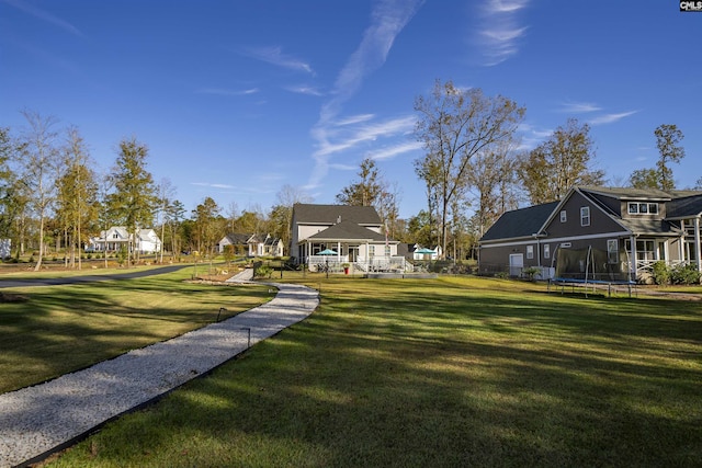 surrounding community featuring a yard and a trampoline