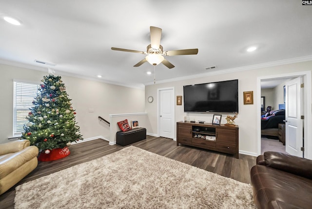 living room with ceiling fan, crown molding, and dark wood-type flooring