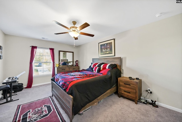 bedroom with ceiling fan and light carpet