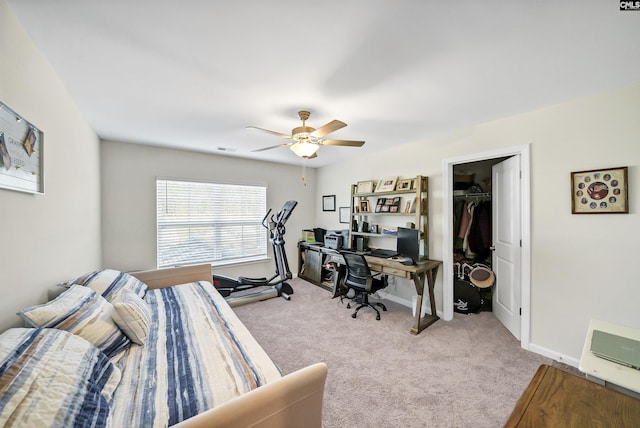 carpeted bedroom featuring a closet, ceiling fan, and a spacious closet