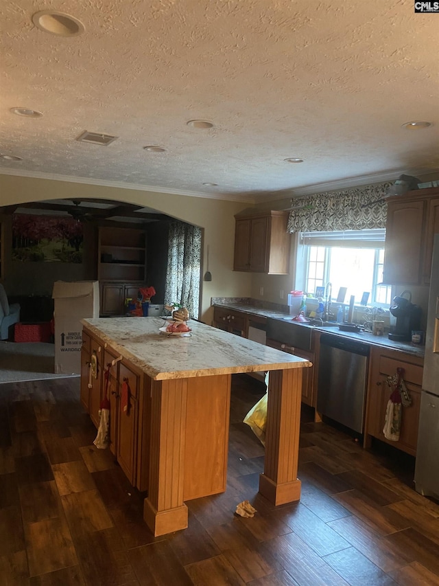 kitchen featuring a textured ceiling, dark hardwood / wood-style flooring, a center island, and dishwasher