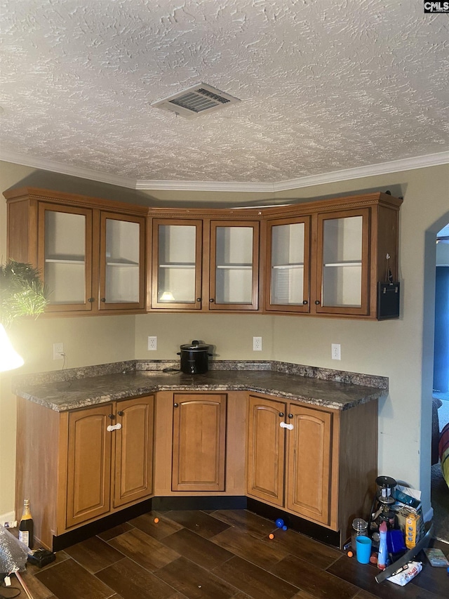 bar with a textured ceiling and ornamental molding