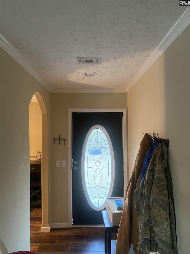 entryway with a textured ceiling and ornamental molding