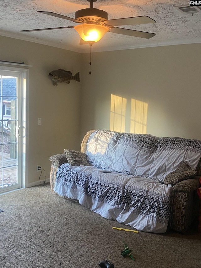 carpeted living room featuring a textured ceiling and ornamental molding