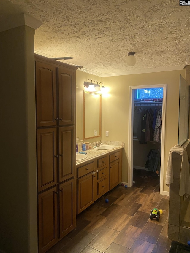 bathroom with a textured ceiling and vanity