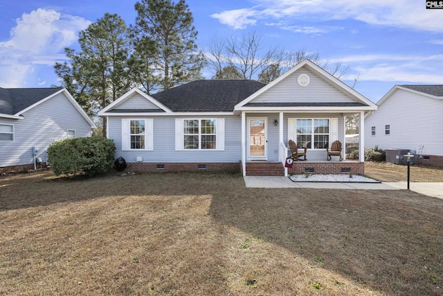 view of front of property with central air condition unit, covered porch, and a front lawn