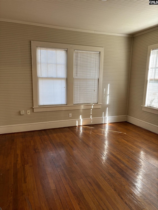 unfurnished room featuring hardwood / wood-style flooring and crown molding