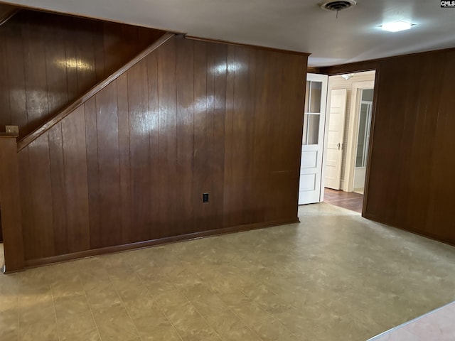 spare room featuring wood walls