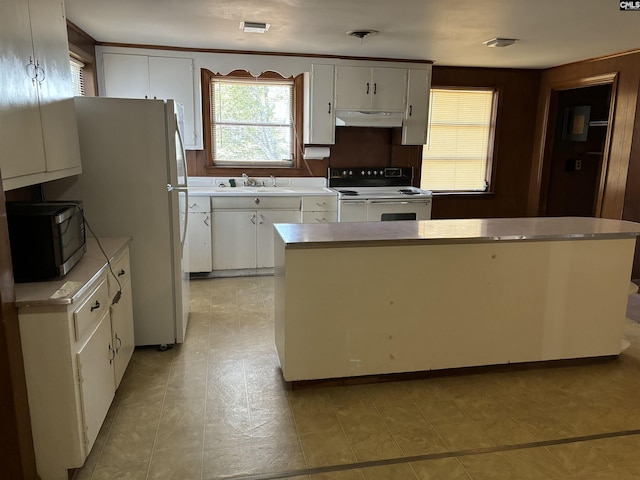 kitchen with sink, a kitchen island, white cabinetry, and appliances with stainless steel finishes