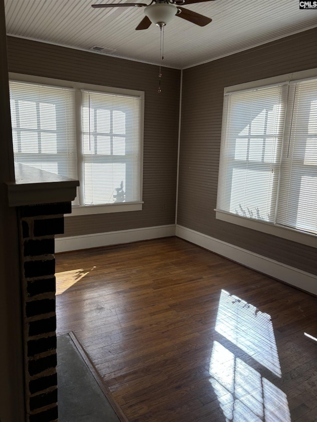 spare room featuring ceiling fan and dark wood-type flooring