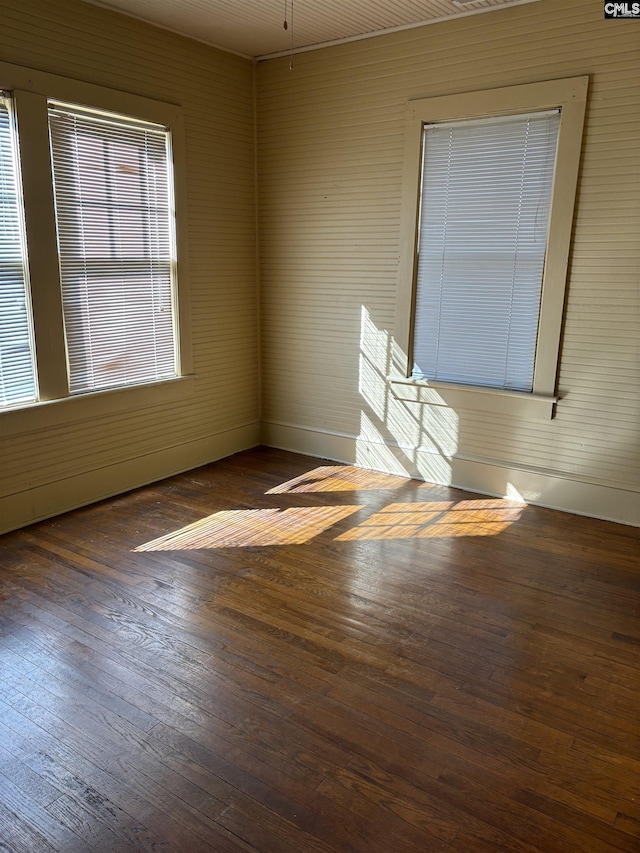 empty room with dark hardwood / wood-style flooring