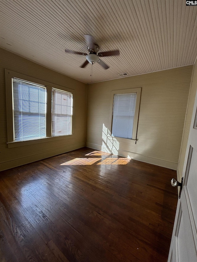 spare room with ceiling fan and dark hardwood / wood-style floors