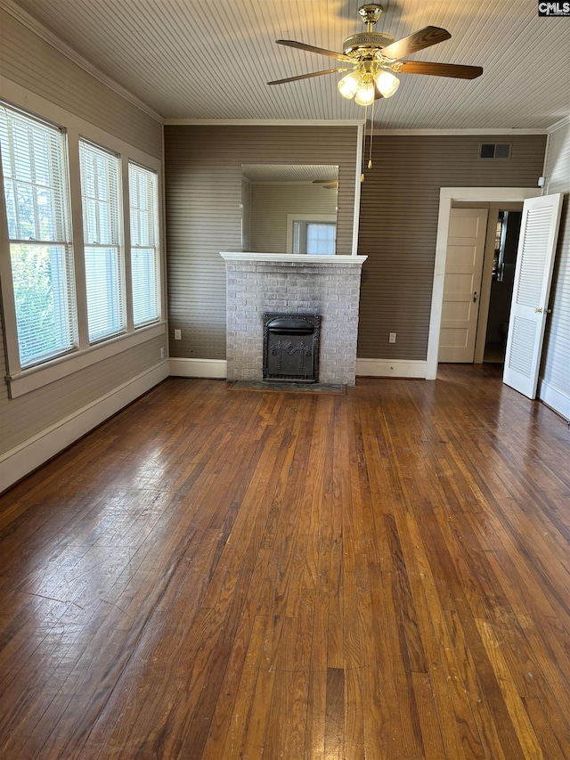 unfurnished living room with ornamental molding, ceiling fan, dark hardwood / wood-style flooring, and a fireplace