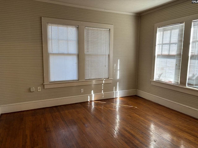 unfurnished room with ornamental molding and hardwood / wood-style floors