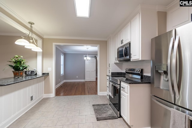 kitchen featuring crown molding, stainless steel appliances, white cabinets, and pendant lighting