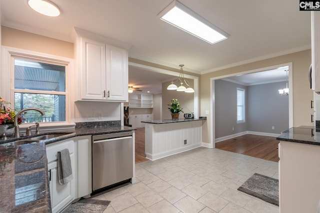 kitchen featuring dishwasher, ornamental molding, sink, white cabinetry, and decorative light fixtures