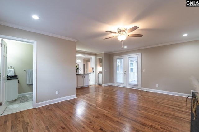 unfurnished living room featuring french doors, hardwood / wood-style floors, ceiling fan, and ornamental molding