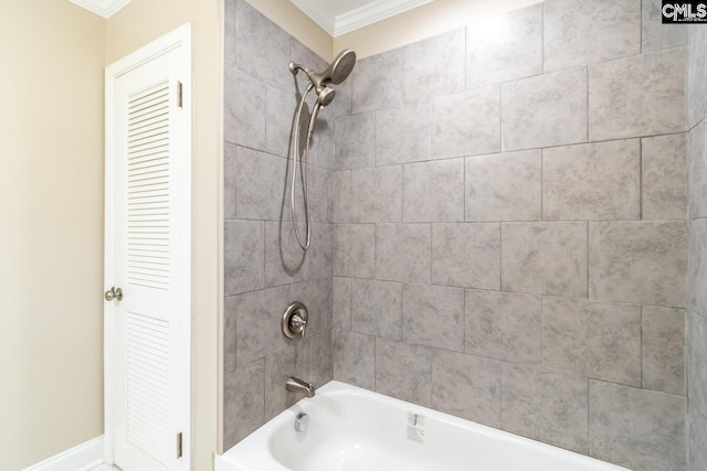 bathroom with ornamental molding and tiled shower / bath combo