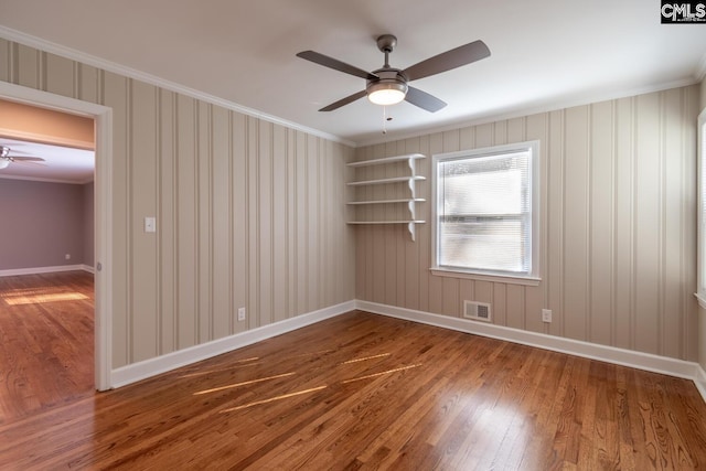 unfurnished room featuring ornamental molding, ceiling fan, and hardwood / wood-style floors