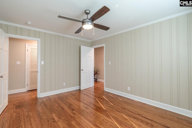 unfurnished bedroom featuring ceiling fan, light wood-type flooring, and ornamental molding