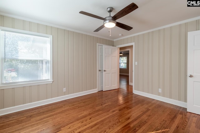 interior space featuring ceiling fan, crown molding, and wood-type flooring